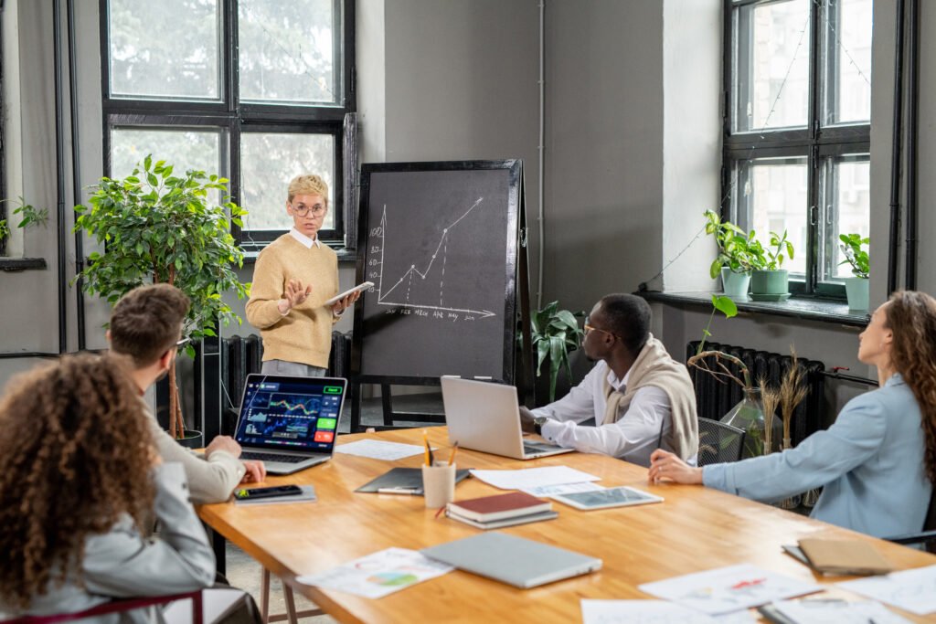 Confident business coach making presentation of financial graph